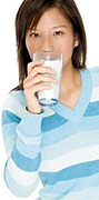 Woman drinking glass of milk. - Copyright – Stock Photo / Register Mark