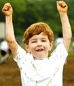 Boy raising his arms in triumph. - Copyright – Stock Photo / Register Mark