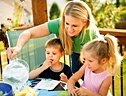 Mother and two children enjoy a meal. - Copyright – Stock Photo / Register Mark