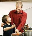 Father and son cooking together. - Copyright – Stock Photo / Register Mark