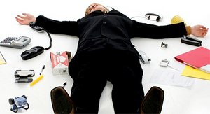 Office worker spread-eagle on the ground surrounded by office supplies. - Copyright – Stock Photo / Register Mark